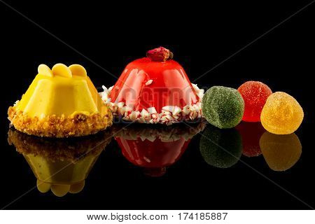colorfull sweet cake on a black background, reflection.
