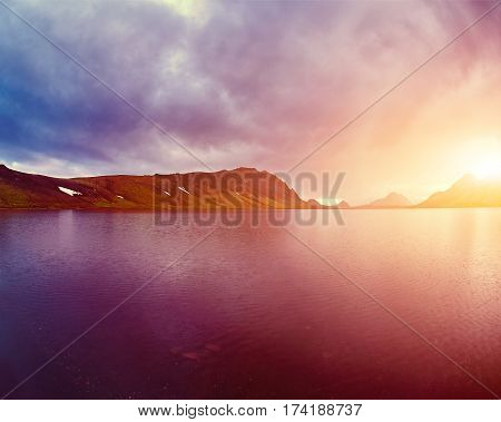 Lake coast with mountain reflection at the sunrise, Iceland. treking in Iceland. Travel concept.