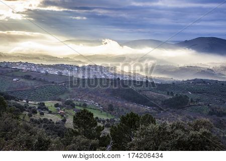 Stunning overview of Guadalupe village during a foggy sunrise Caceres Spain