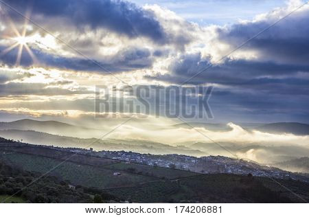 Stunning overview of Guadalupe village during a foggy sunrise Caceres Spain