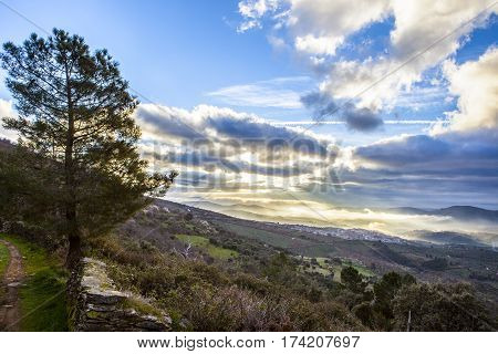 Stunning overview of Guadalupe village during a foggy sunrise Caceres Spain