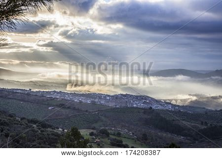 Stunning overview of Guadalupe village during a foggy sunrise Caceres Spain