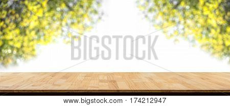 wooden table in front of abstract Blur green leaves and branches Natural background