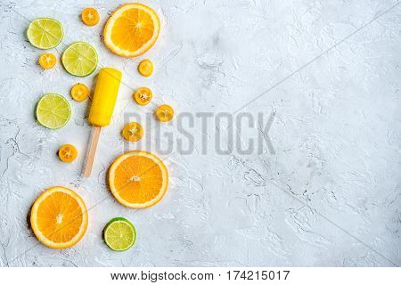 Homemade orange icecream with fresh fruits on stone table background top view mock-up