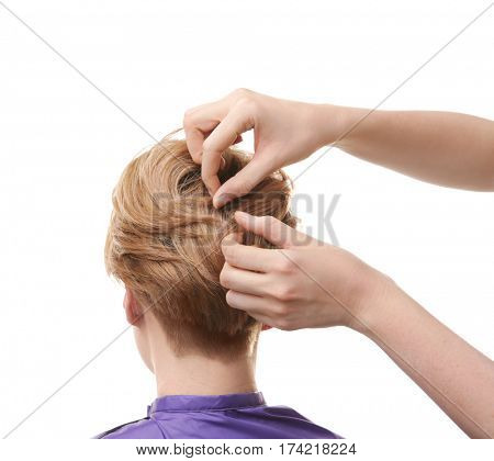 Hairdresser working with client on white background