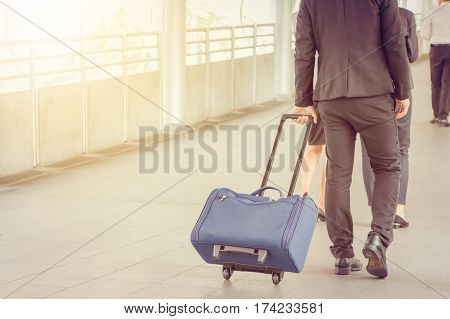 Businessman and businesswoman traveler with luggage at city background Business People Commuter Walking City Life Concept.