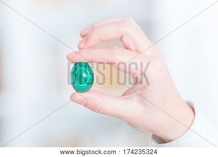 Malachite semi preciouse gemstone in hand