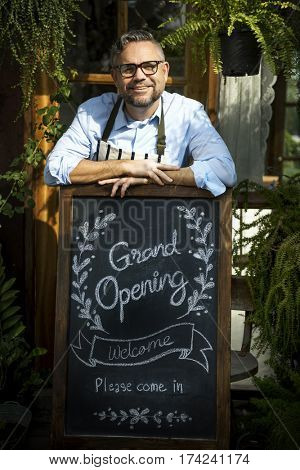 Adult Man Standing with Grand Opening Sign