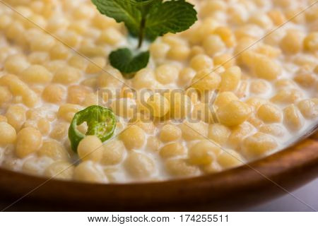 Dahi Bundi or Boondi Raita, favourite indian started or side dish made using Rajasthani snack food made from sweetened, fried chickpea flour, called Boondi with sweet and salty curd or buttermilk