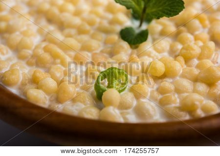 Dahi Bundi or Boondi Raita, favourite indian started or side dish made using Rajasthani snack food made from sweetened, fried chickpea flour, called Boondi with sweet and salty curd or buttermilk