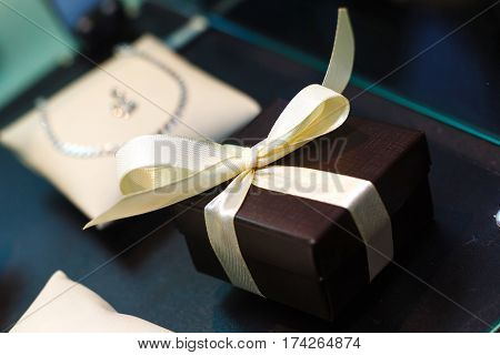 gift box with golden ribbon, glittery gold background gift box bow