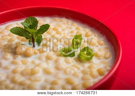 Dahi Bundi or Boondi Raita, favourite indian started or side dish made using Rajasthani snack food made from sweetened, fried chickpea flour, called Boondi with sweet and salty curd or buttermilk