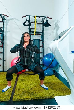 The female athlete doing they exercise in the EMS fitness studio