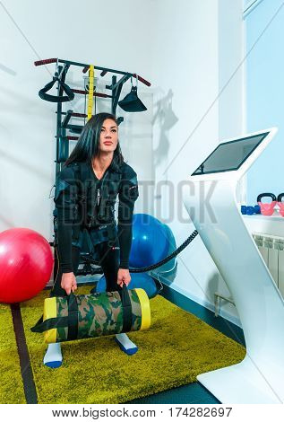 The female athlete doing they exercise in the EMS fitness studio