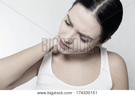 health people Sport and lifestyle concept - Tired Neck. Beautiful Young Woman Suffering From Neck Pain. Attractive Female Feeling Tired Exhausted Stressed. Girl Massaging Painful Neck With Hand.