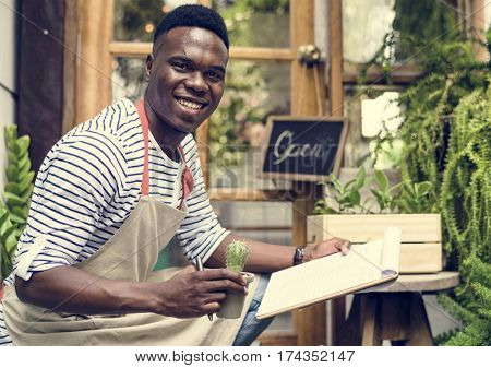 Adult Man Checking Plants Outside Flower Shop