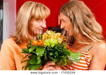 Mother and daughter ÃÂ¢Ã?Ã? the daughter has given her mother flowers