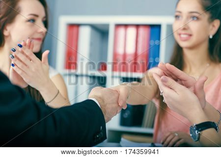 Close up of business handshake in the office. Serious business and partnership concept. Partners made deal sealed with handclasp.