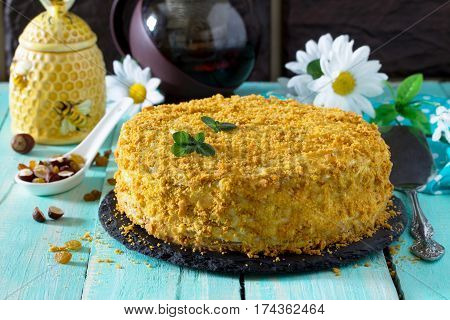 Homemade Honey Cake With Sour Cream On A Wooden Table With Raisins And Nuts.