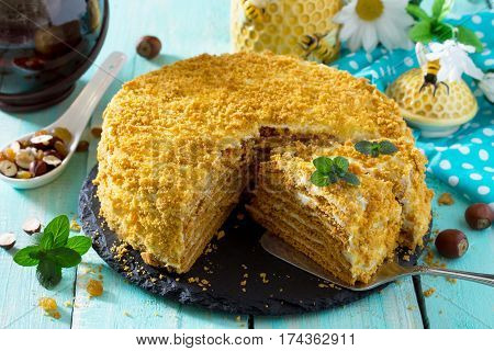Sweet Home Layered Honey Cake On A Wooden Table With Raisins And Nuts.