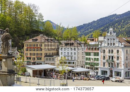 EINSIEDELN SWITZERLAND - MAY 09 2016: Colorful buildings of the city and stalls in which variety of souvenirs are put on sale. The town is widely known because of Einsiedeln Abbey