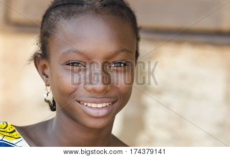 African sad teenage girl smiling and looking at camera in Bamako Mali.