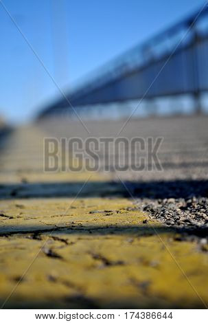 Photographed at the time of the sunset with the reflection of a fence on the bridge Varadin of yellow tape on the sidewalk above the Danube River in Novi Sad, Serbia