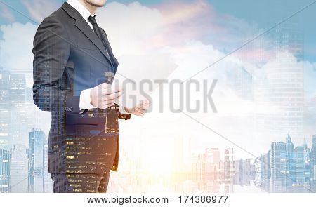 Close up portrait of an unrecognizable buisnessman with documents satnding against a morning city panorama. Double exposure toned image mock up