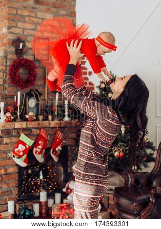 Beautiful moter and her little daughter  near Christmas tree