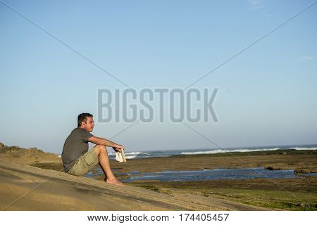 Man On Rocks With Book And Music