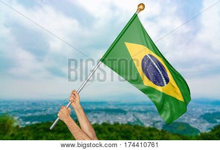 Young man's hands proudly waving the Brazil national flag in the sky, part 3D rendering