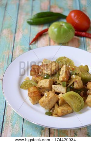 Stir fried tofu with green tomato and chili or Oseng Tahu, Indonesian food