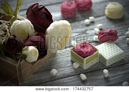 Red And White Buttercup Flowers Ranunculus White And Pink Zephyr Marshmallows On Gray Wooden Backgro