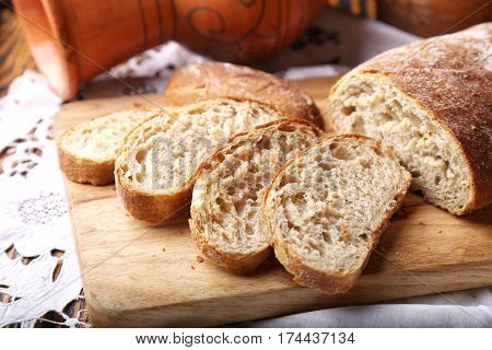 Freshly baked ciabatta bread on wooden cutting board