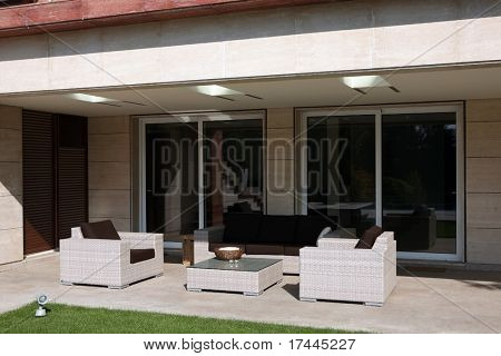 two armchairs and sofa in front of house