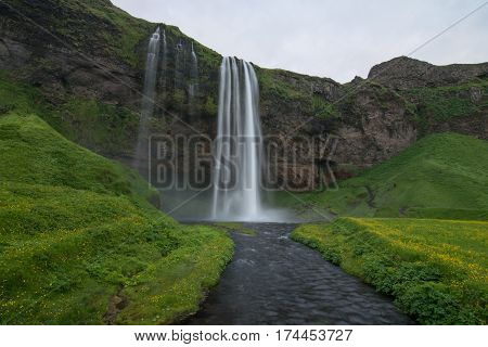 Scenic waterfall in pristine nature landscape of Iceland
