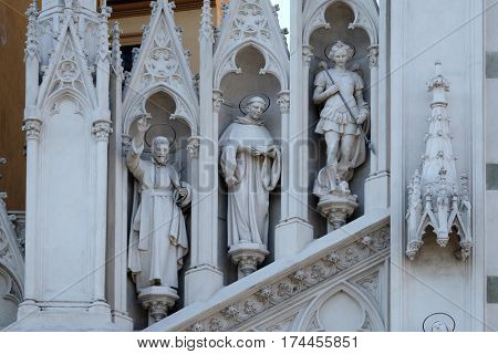 ROME, ITALY - SEPTEMBER 02: Statues of St. Francis Xavier, Dominic of Guzman and Michael Archangel on the facade of Sacro Cuore del Suffragio church in Rome, Italy  on September 02, 2016.
