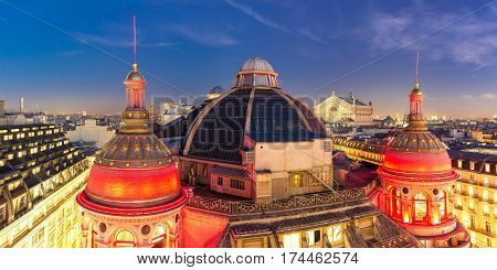 Aerial panoramic view of Opera Garnier, Neo-Renaissance Printemps gallery dome at night, Paris, France