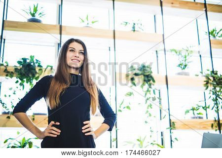 Young business woman near the window in the office.