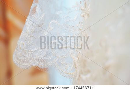 Beautiful white background of the wedding dresses with embroidery and ornaments