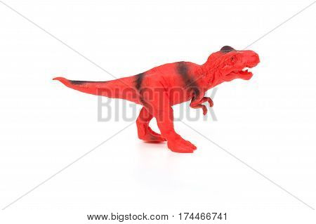 red and black tyrannosaurus toy on a white background