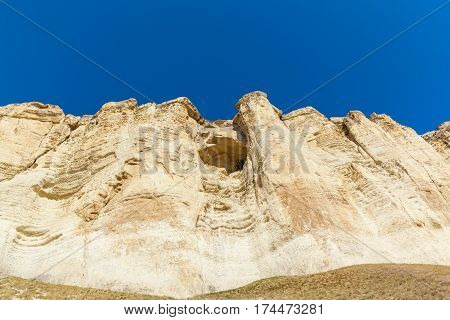 View of White rock or Aq Qaya on a Sunny summer day. Crimea. White limestone with a vertical cliff