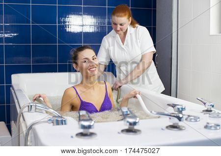 Young woman during hydromassage in beauty salon