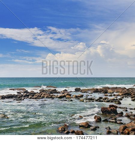 Scenic ocean coral reef near the shore and blue sky.