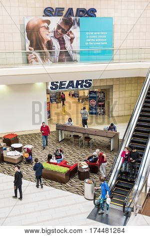 Fairfax USA - February 18 2017: Sears sign exterior in mall with escalator and closure sign