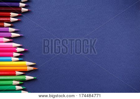 background from color pencils on blue paper. Place for the text. Art and design. Drawing and painting. Artist. School and education.