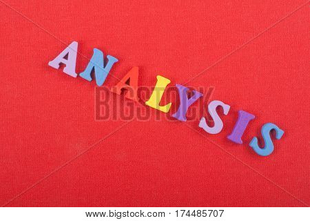 Word "ANALYSIS" on red background composed from colorful abc alphabet block wooden letters copy space for ad text. Learning english concept