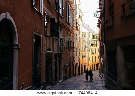 GENOA, ITALY - OCTOBER 23, 2016: Couple walking down the street of Genoa, one of Europe's largest cities on the Mediterranean sea and the largest seaport in Italy.