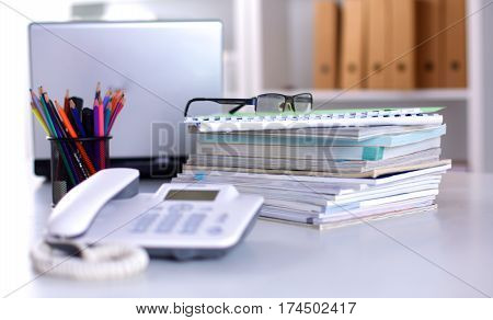 Group of multicolored office folders and glasses.