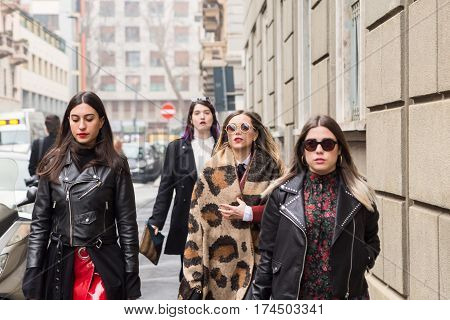 MILAN ITALY - FEBRUARY 23: Fashionable women pose outside Les Copains fashion show during Milan Women's Fashion Week on FEBRUARY 23 2017 in Milan.